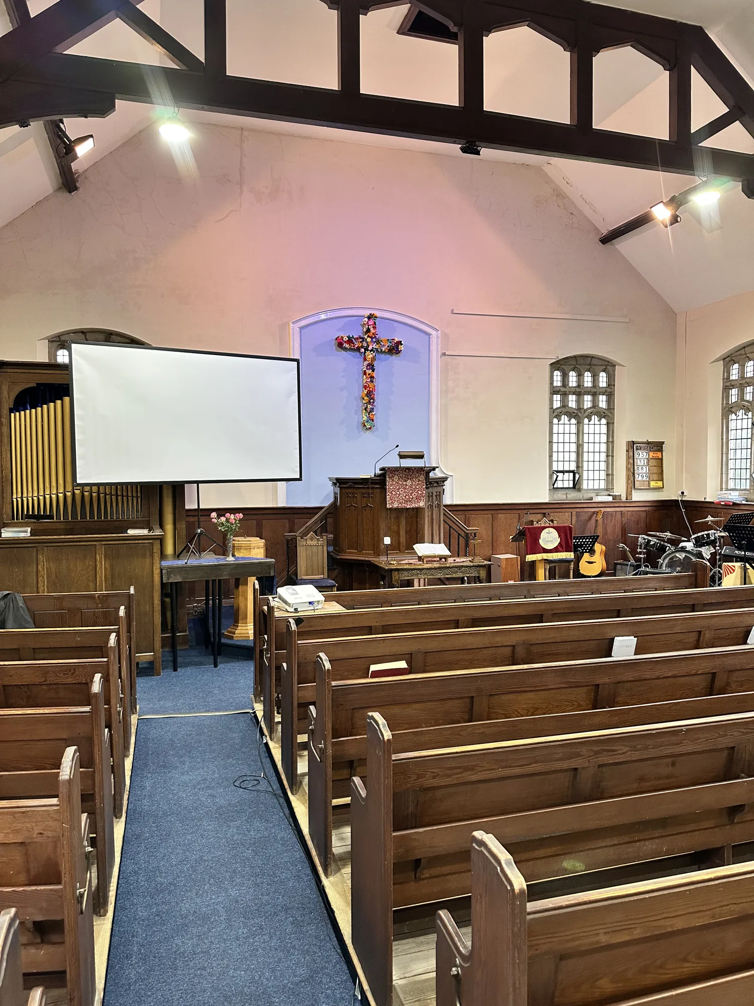 Church interior viewed down the aisle under new spotlights