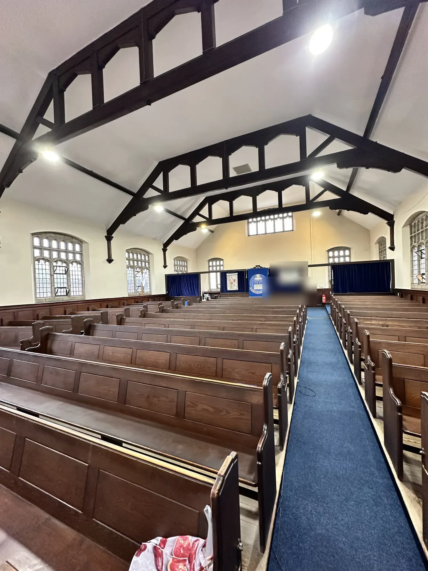 Church interior lit by new ceiling spotlights down the central aisle