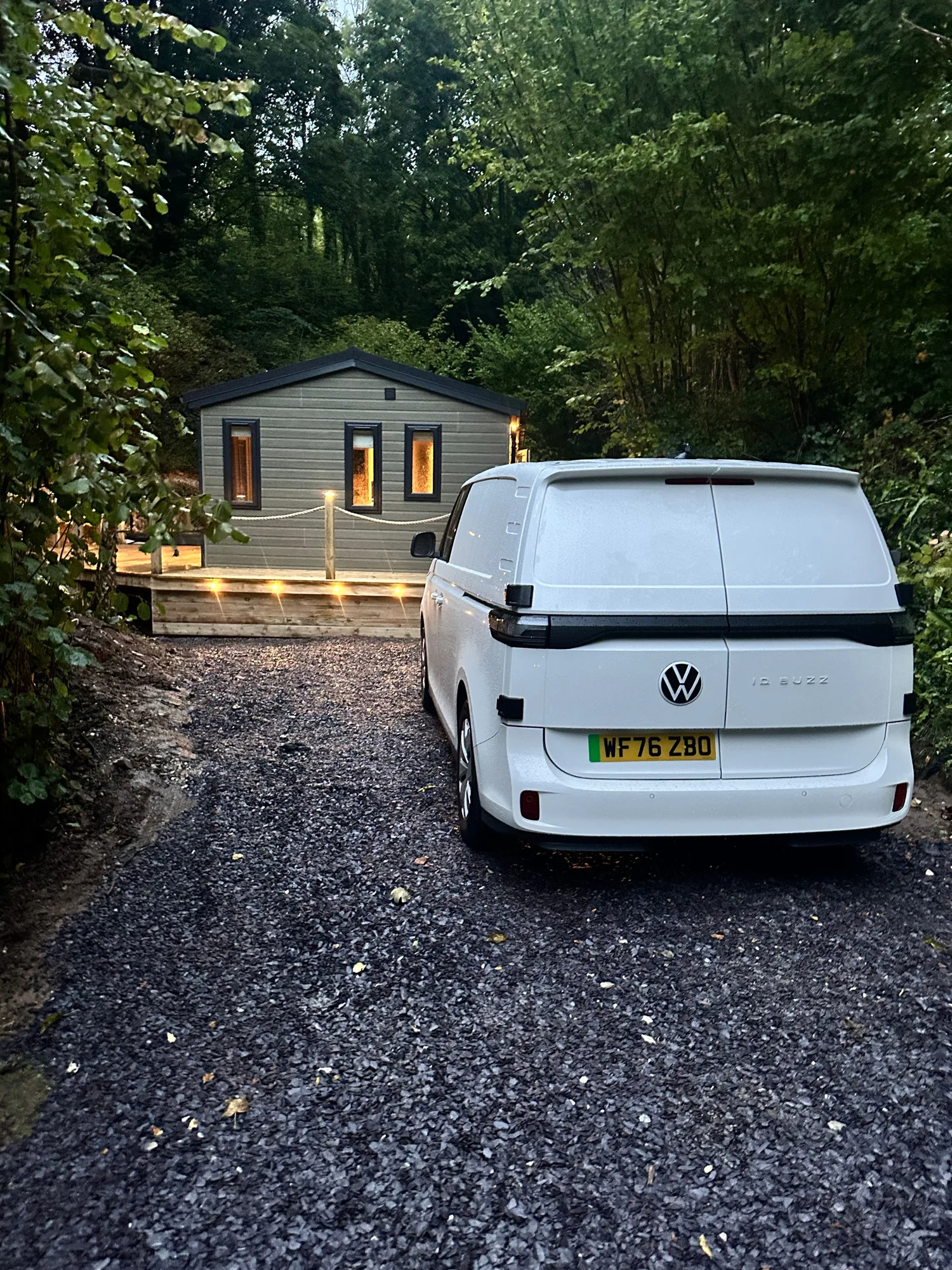 Prometheon van parked outside a holiday lodge at dusk