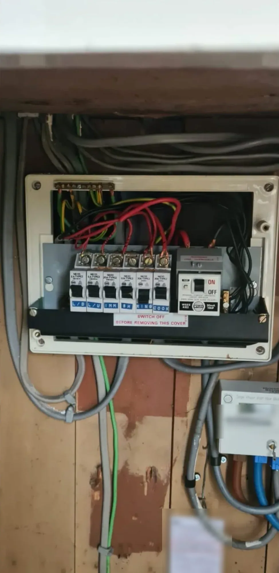 Consumer unit and wiring in a timber-lined meter cupboard