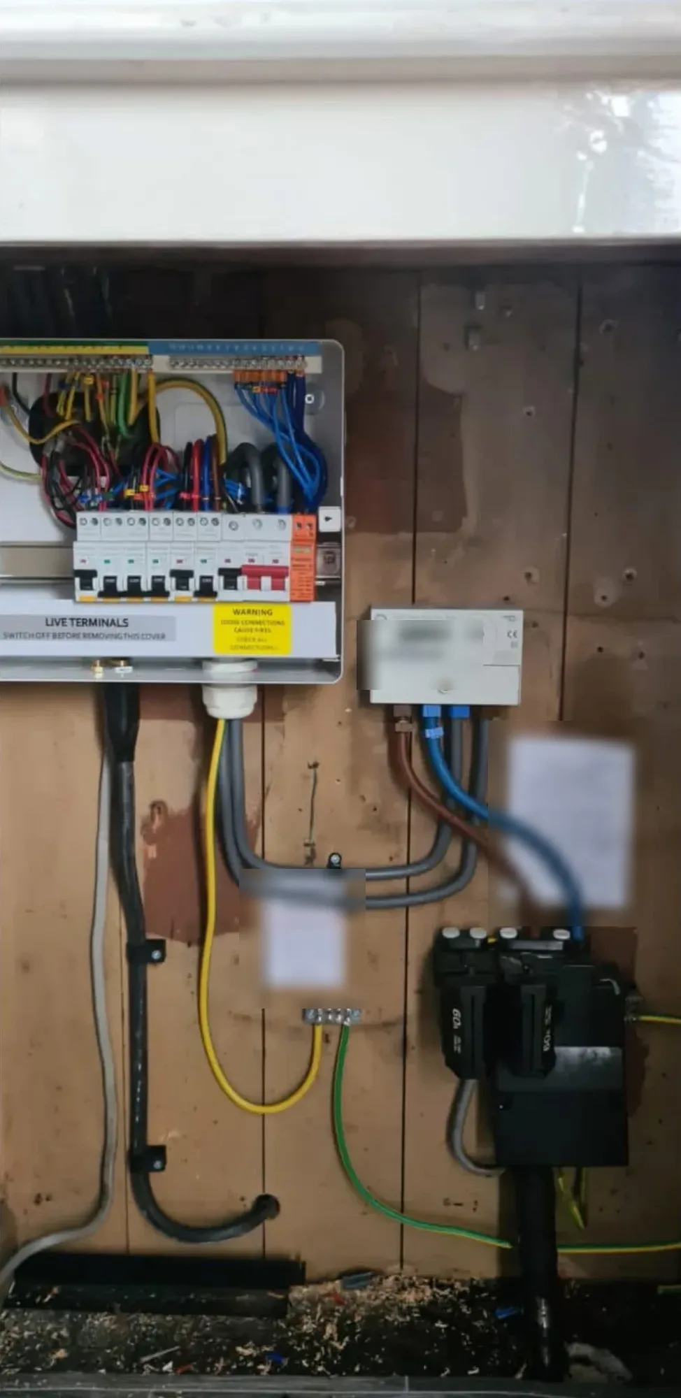 Consumer unit, meter and supply cables in a meter cupboard