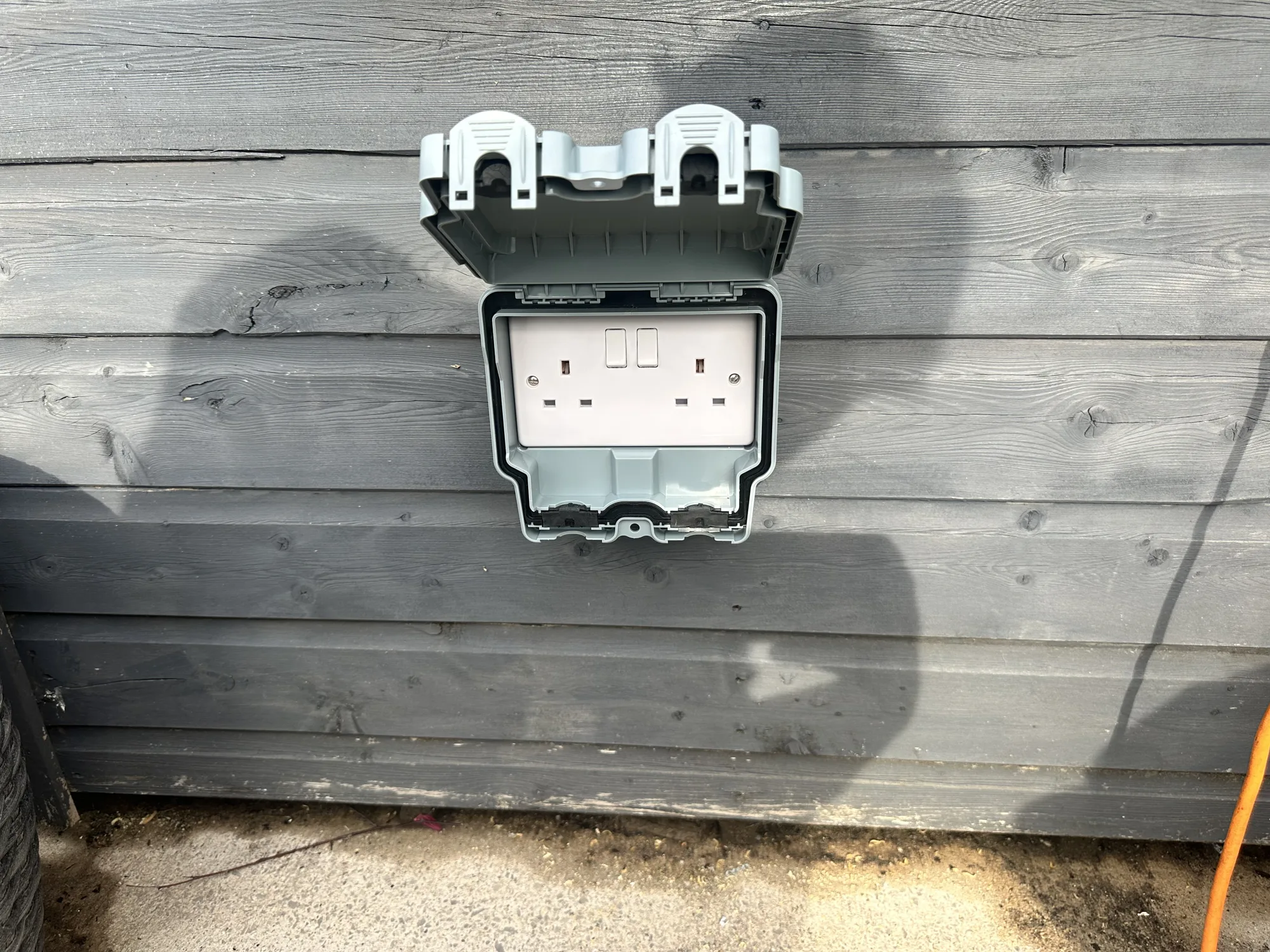 New weatherproof outdoor double socket fitted to a timber wall